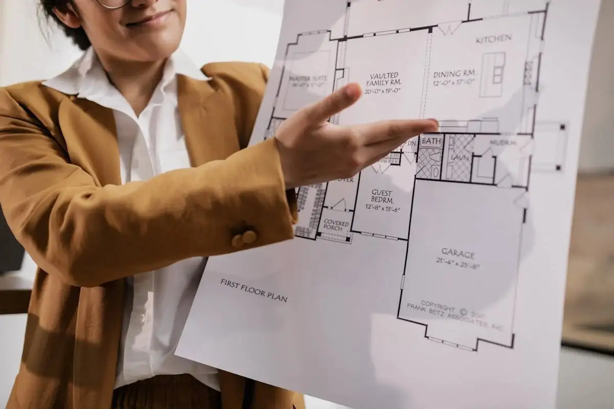 A real estate agent presenting blueprint of the house A real estate agent presenting blueprint of the house