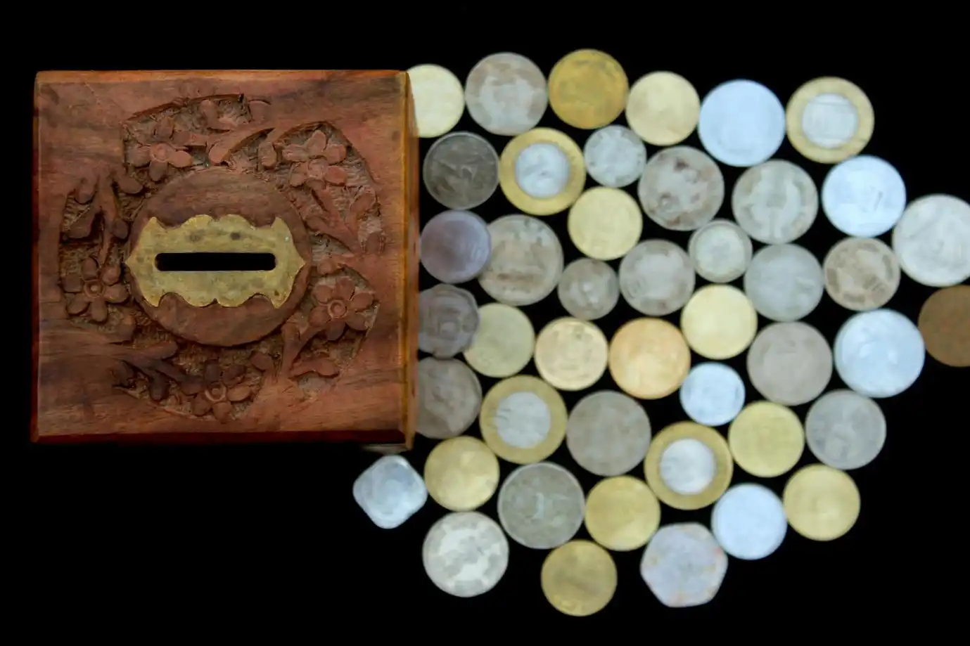 A wooden box with Indian rupee coins A wooden box with Indian rupee coins