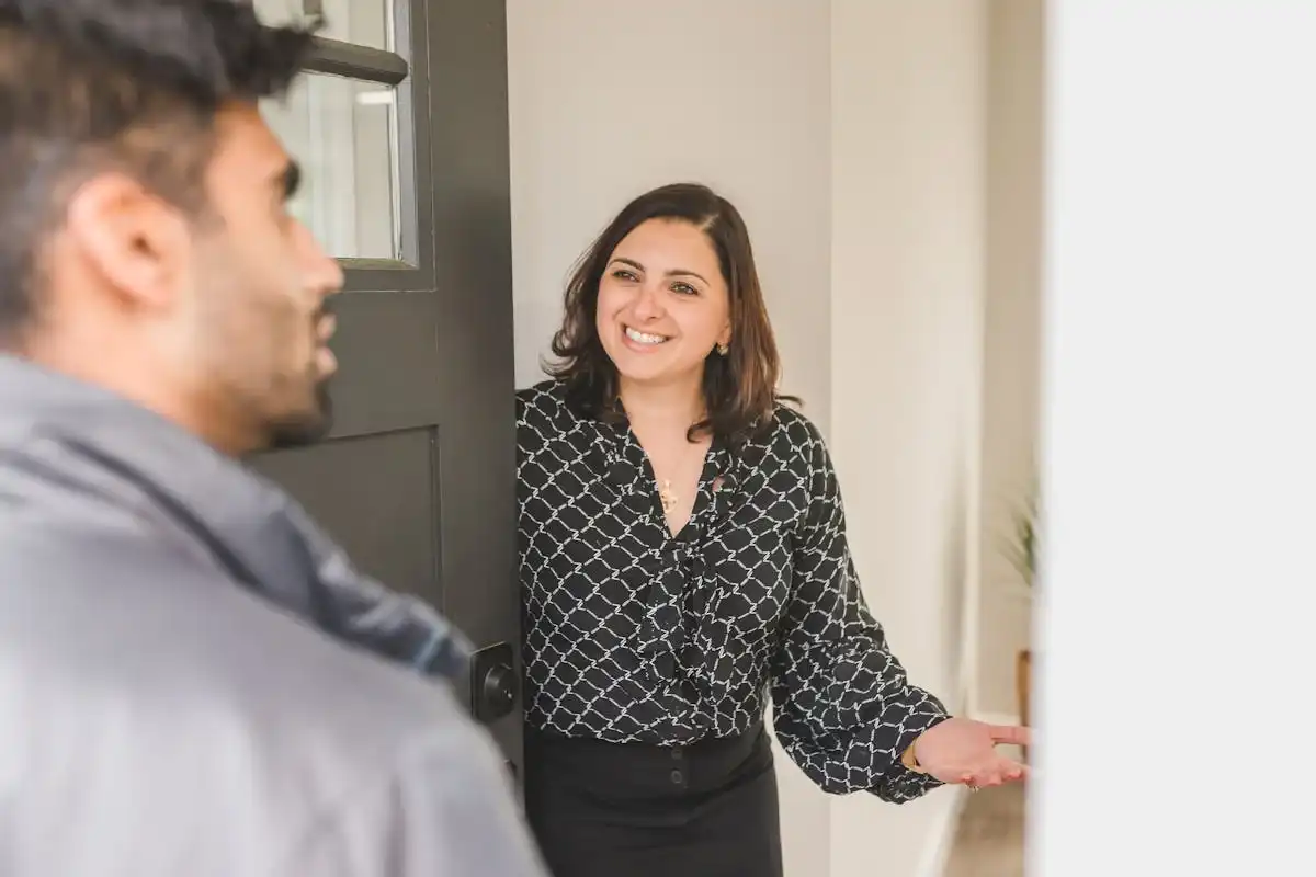 An agent welcoming client into a ready-to-buy apartment