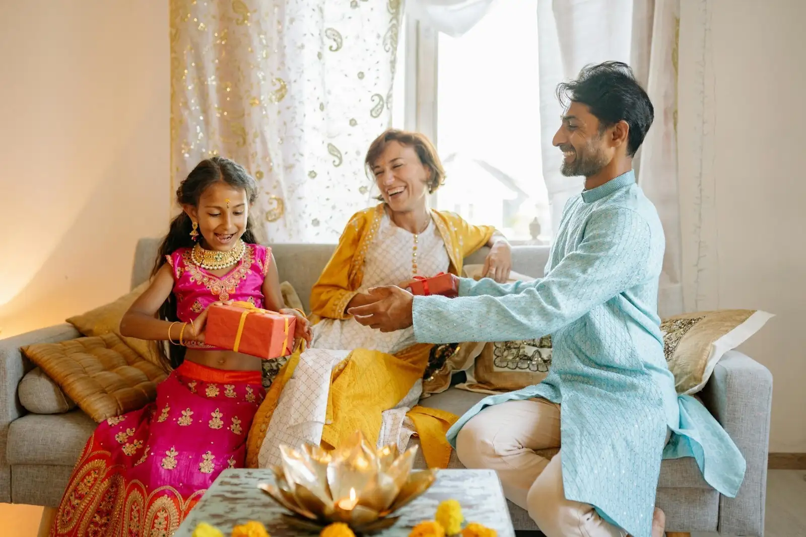 Parents giving a gift to their daughter during Diwali Parents giving a gift to their daughter during Diwali