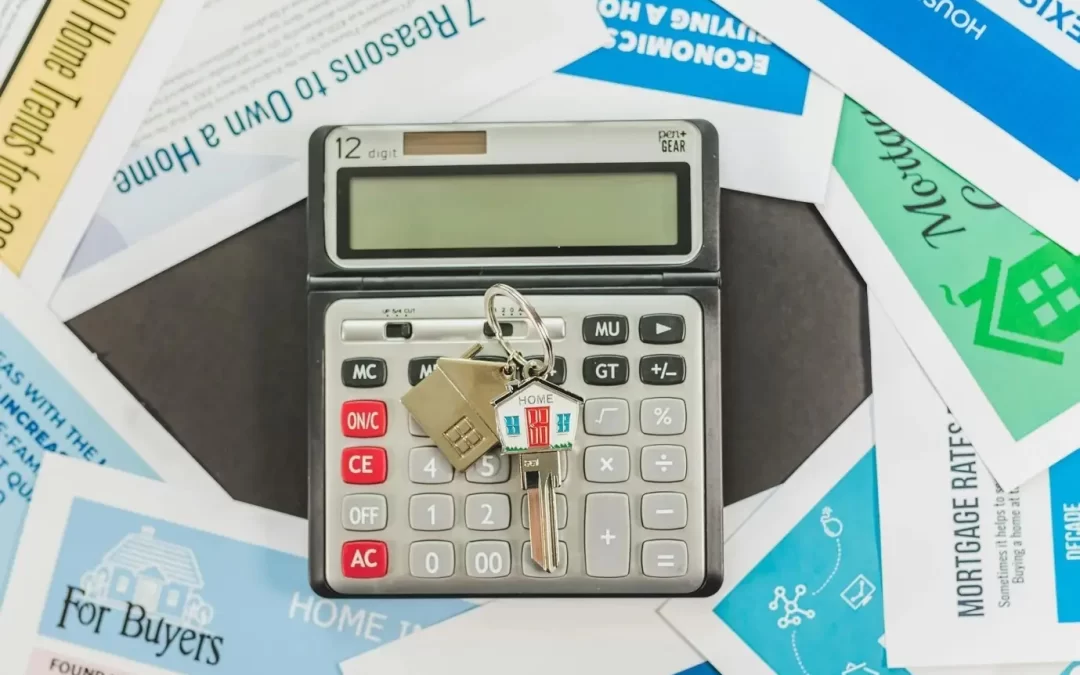 A house key on a calculator atop various documents for property buyers in Goa.