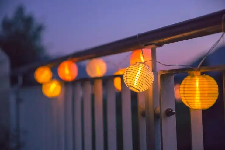 Lights hanging from the balcony railing