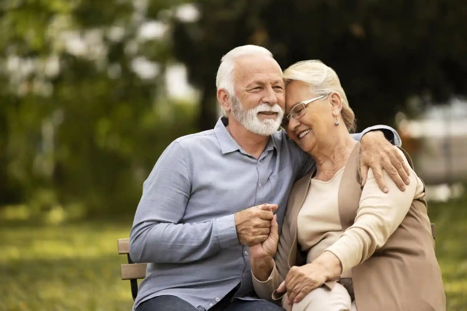 Elderly couple happily sitting on a bench Elderly couple happily sitting on a bench
