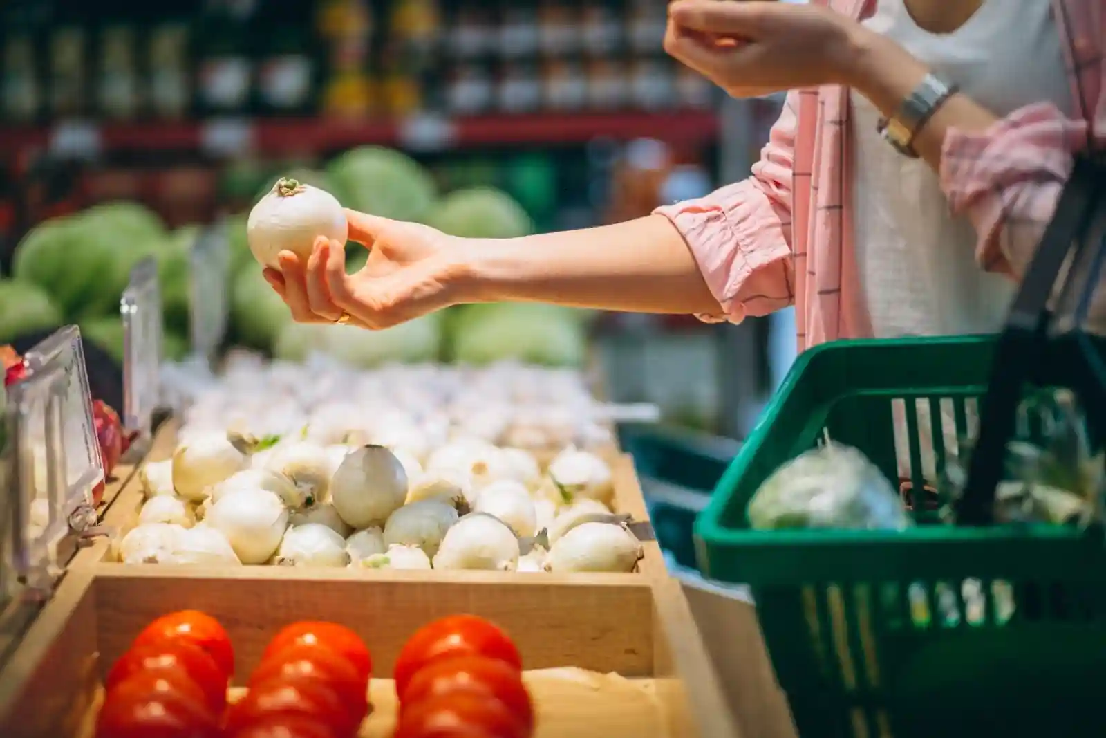 A woman picking out groceries in a market.