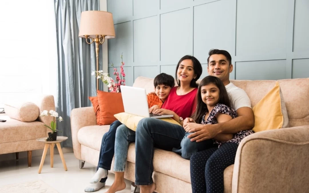 Family sitting on the couch in an apartment with a good neighbourhood.