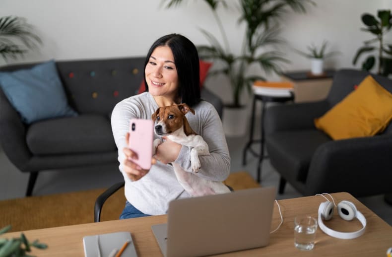 A woman taking a selfie with her dog in a pet-friendly home in Goa.