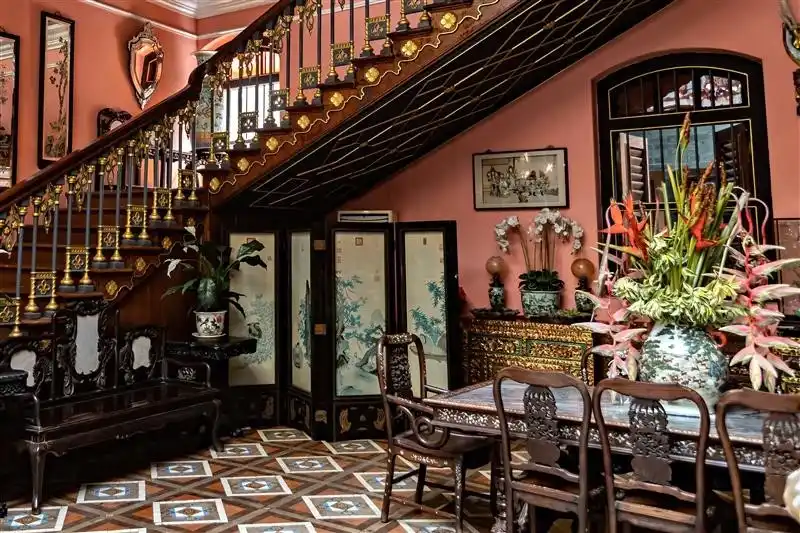A room with carved wooden furniture, metal work and ornate interior design.
