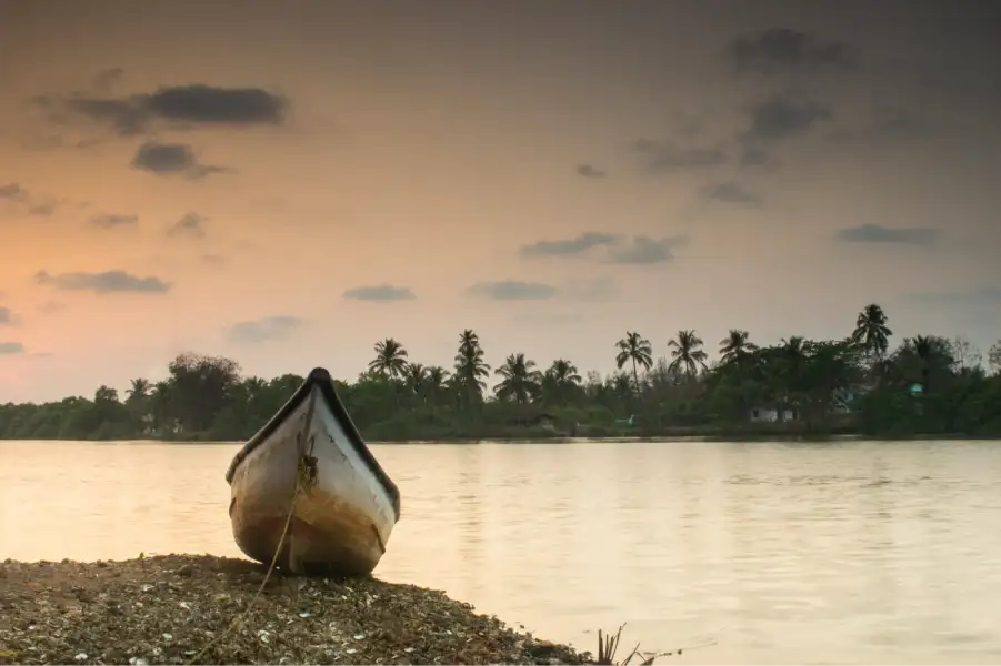 A boat at the shore of a beach in Goa during monsoons.
