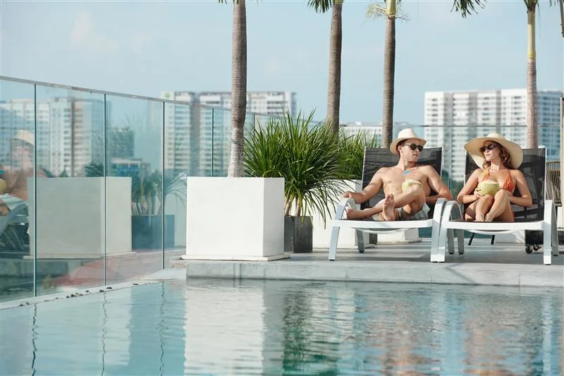 A couple relaxing near the pool in an apartment complex.