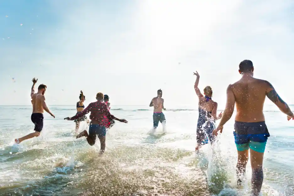 People enjoying themselves on a beach in Goa.