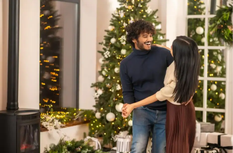 A couple dancing in front of the Christmas tree in their home in Goa