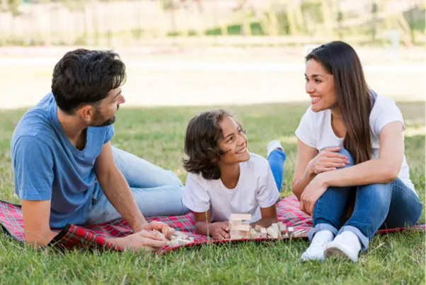 A family enjoying a day in the park during winter in Goa.)