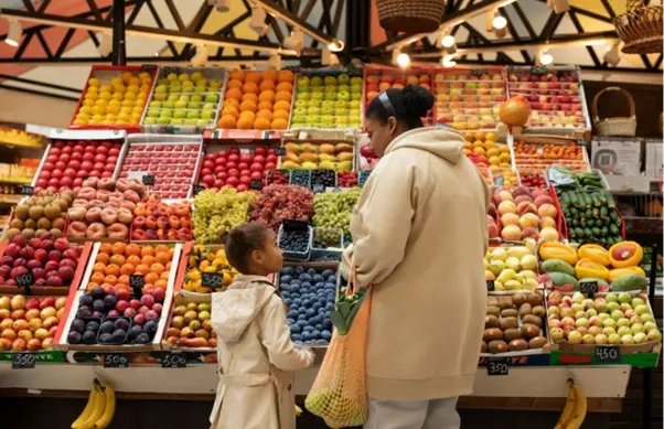 Mother and daughter shopping at a market on the way back to their home in Goa
