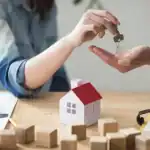 A woman giving a man the keys to his new home in Goa