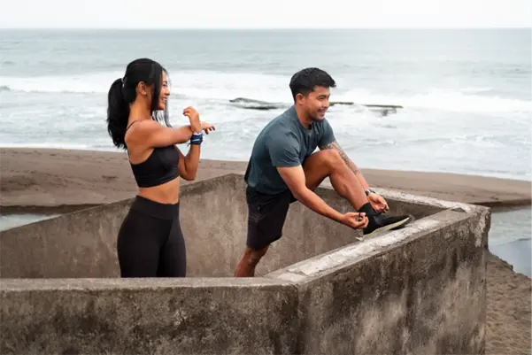 People stretching at beach side view