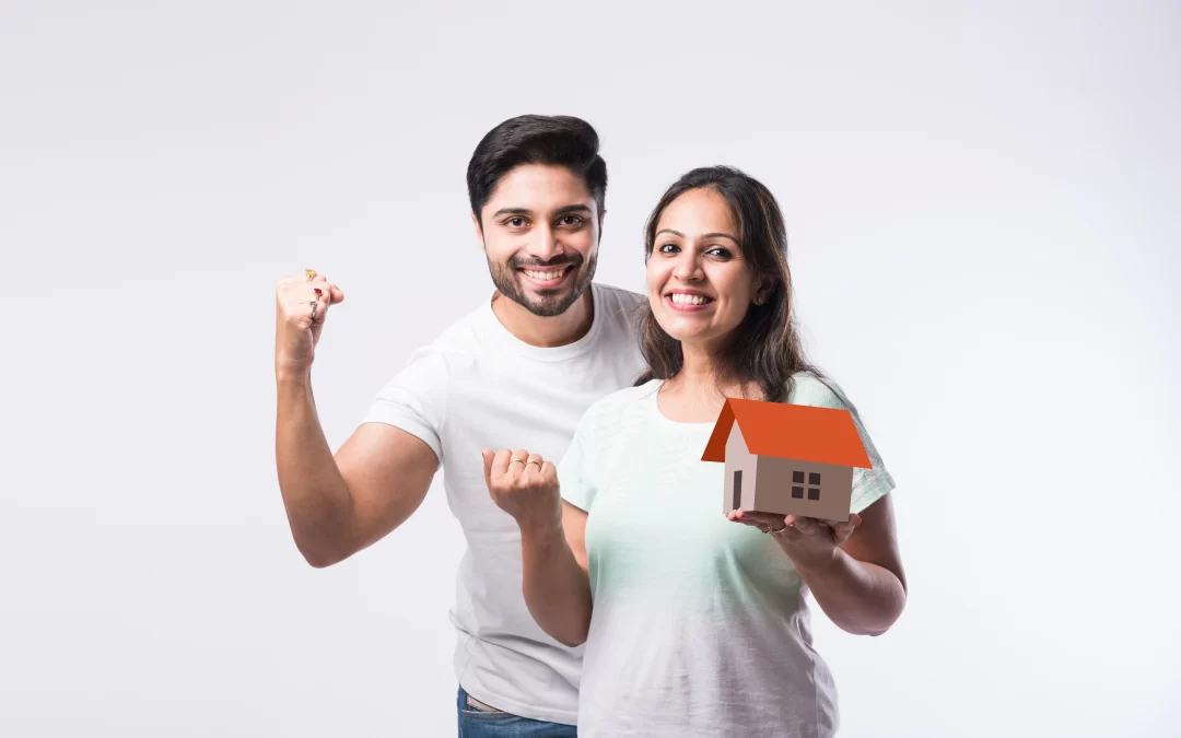 A couple looking happy with a model of their home in Goa.