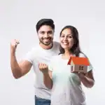 A couple looking happy with a model of their home in Goa.