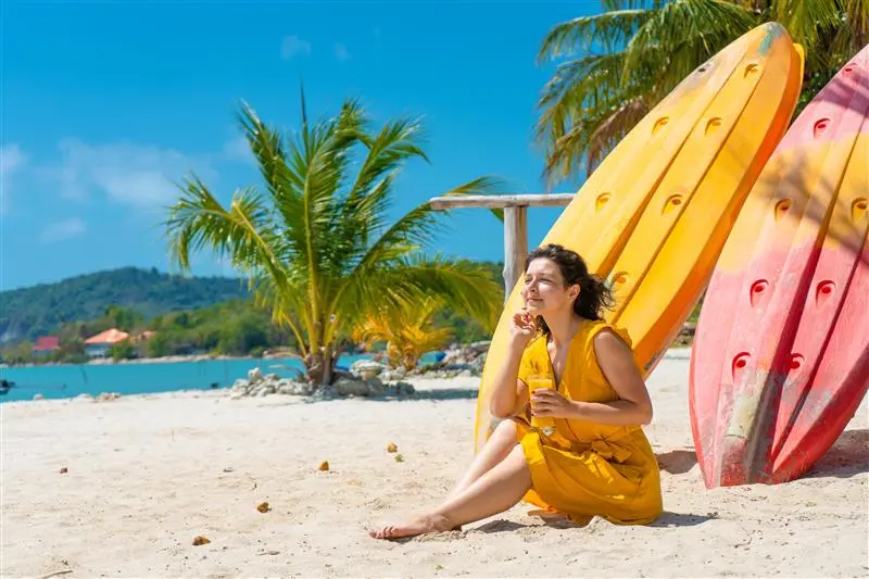 Sunlit waves crashing on a Goan beach near a property in Goa.