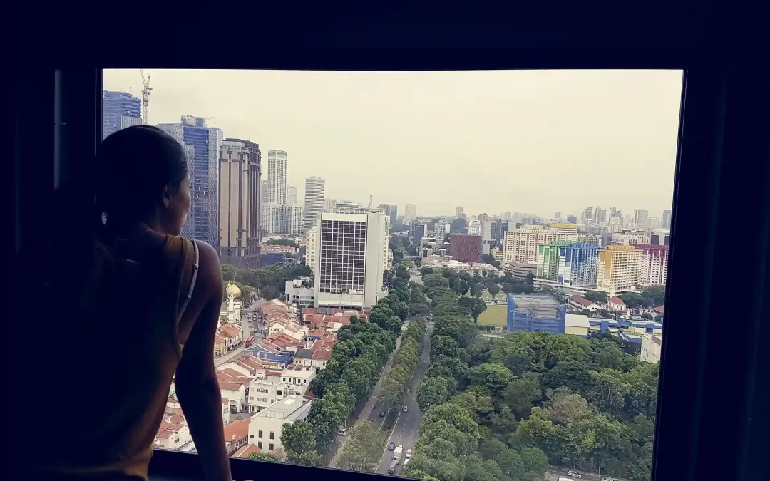 A woman looking out of the window of her home in Goa