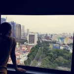 A woman looking out of the window of her home in Goa