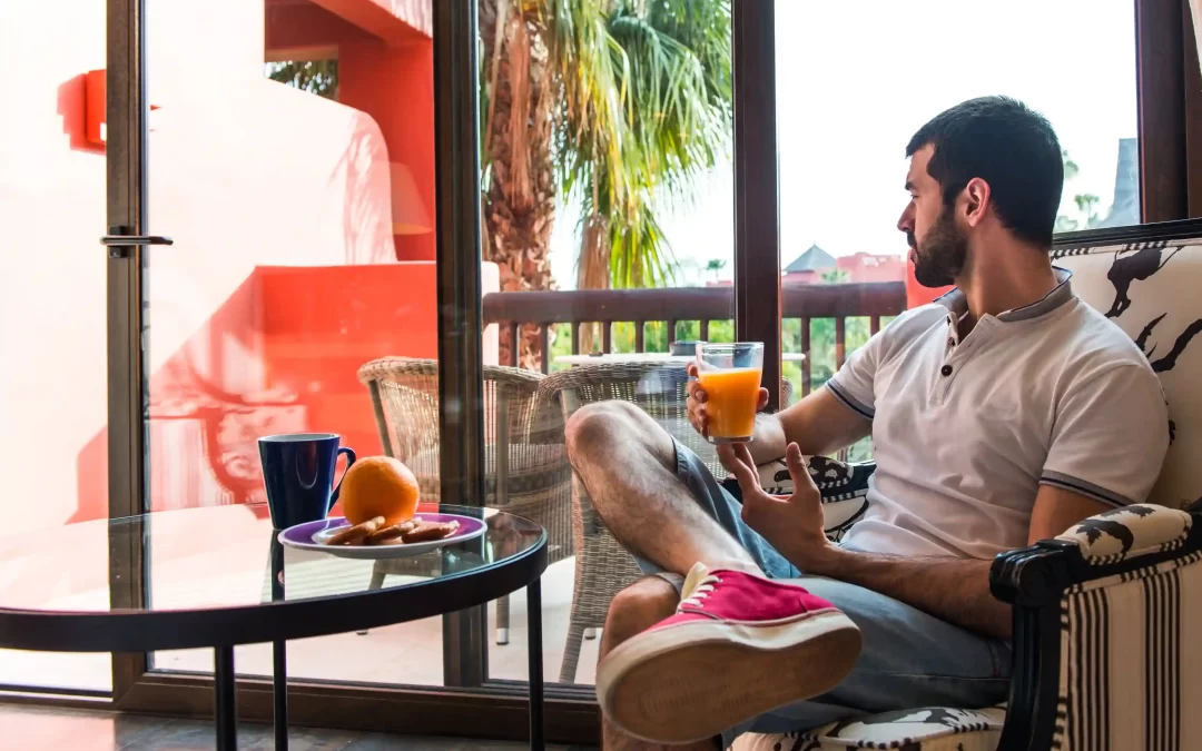 A man enjoying some juice on a hot day in his home in Goa.