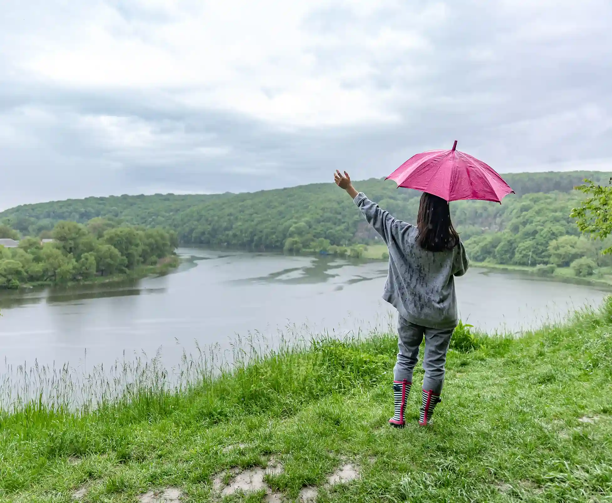 Woman with an umbrella exploring the lush green landscape of Goa during the monsoon, which is always within reach with a home in Panjim.