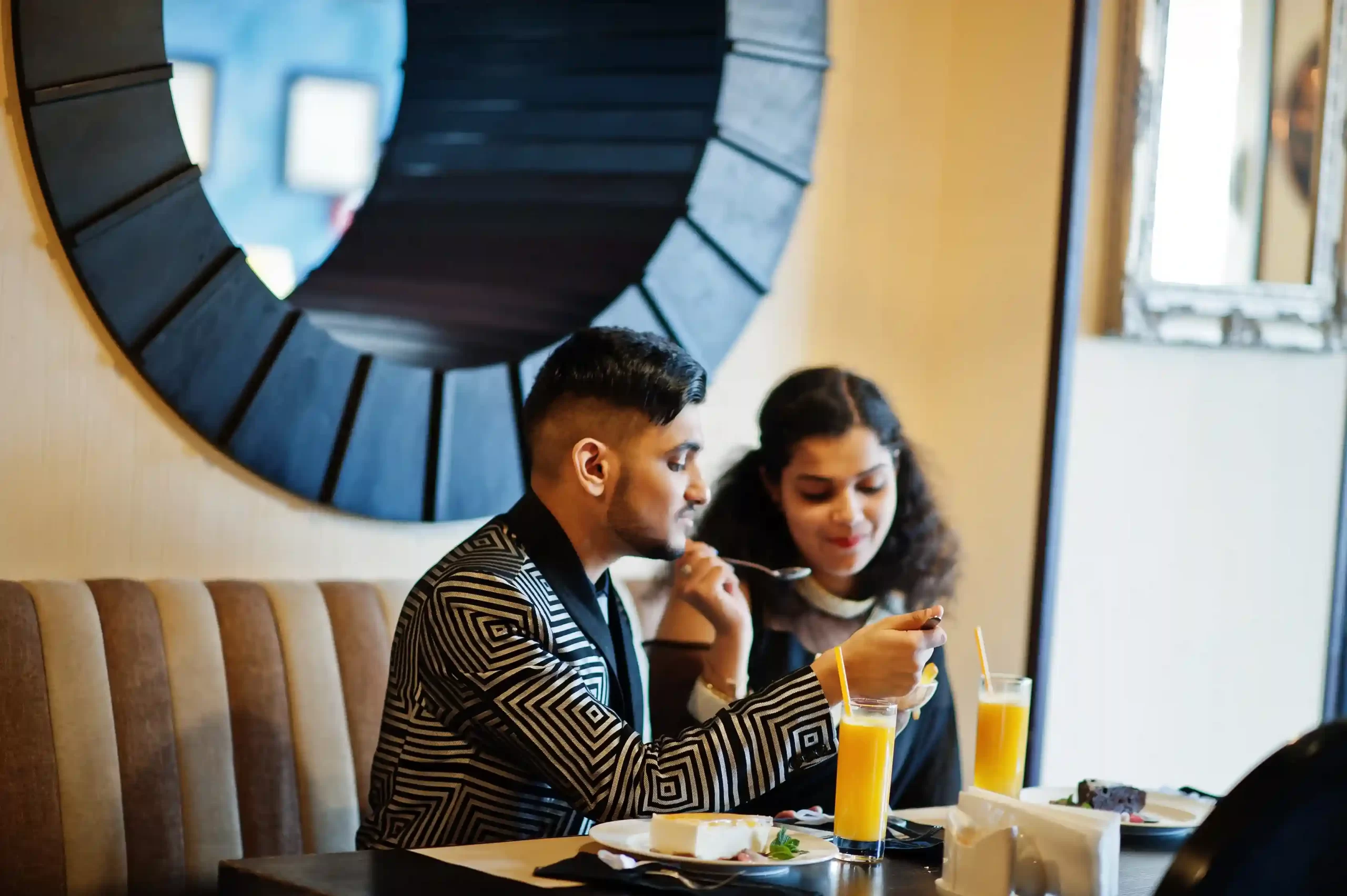 A couple eating food at a cafe near their home in Goa.