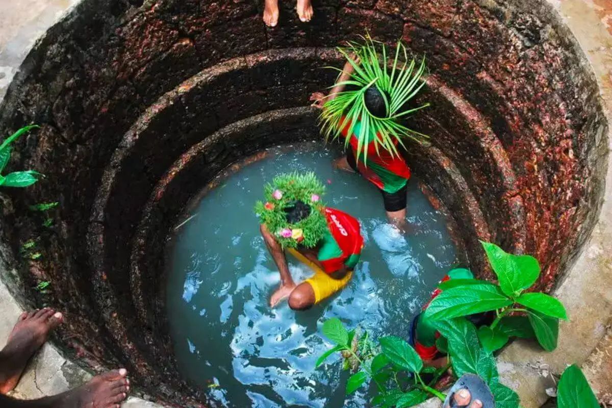 Locals celebrating the São João festival during the monsoon in Goa near a property in Goa.<br /> 