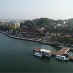 Goa cityscape showcasing homes in Panjim, greenery, and the Mandovi waterfront.