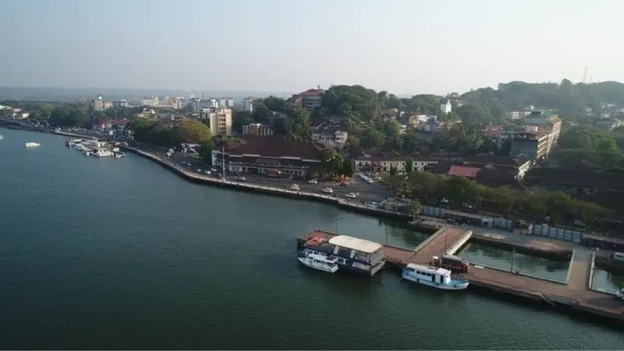 Goa cityscape showcasing homes in Panjim, greenery, and the Mandovi waterfront.