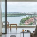 A resident enjoying a scenic river view from an apartment home in Goa